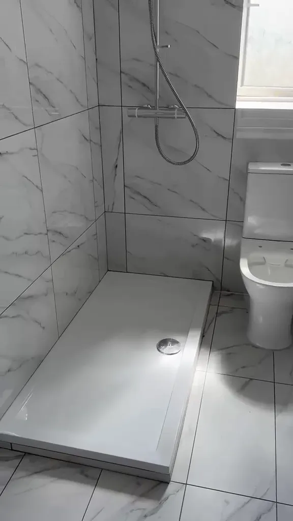 Marble-effect bathroom with a walk-in shower.