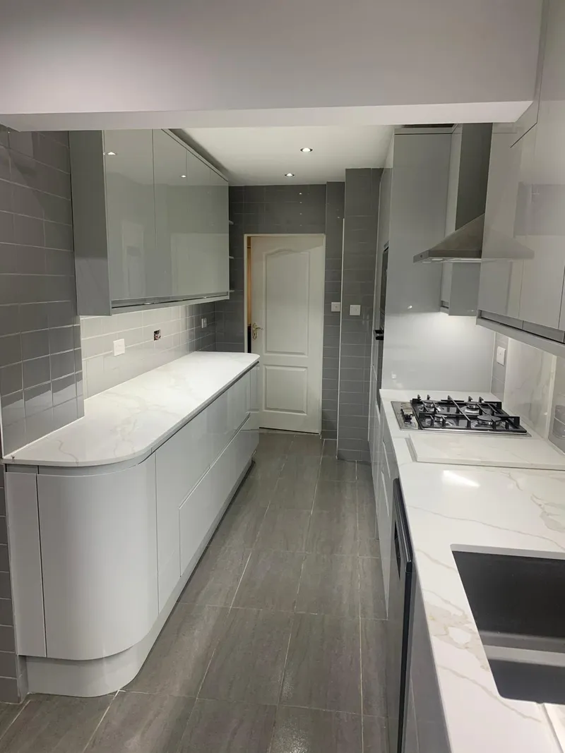 Grey gloss kitchen with curved end units.