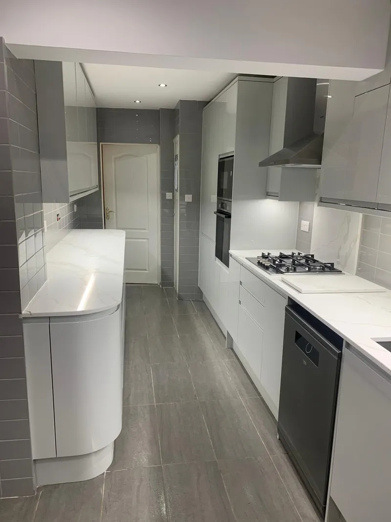 Gas hob set into a marble-effect quartz worktop.